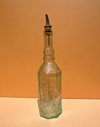 Glazen oliefles met motief